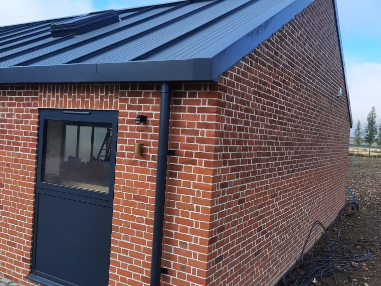 The finished construction of gym building with steel roof